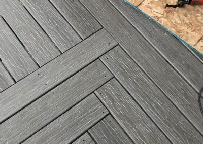 Dark composite decking and press board in corner